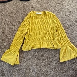 Ruffled arms and ruffle patterned top